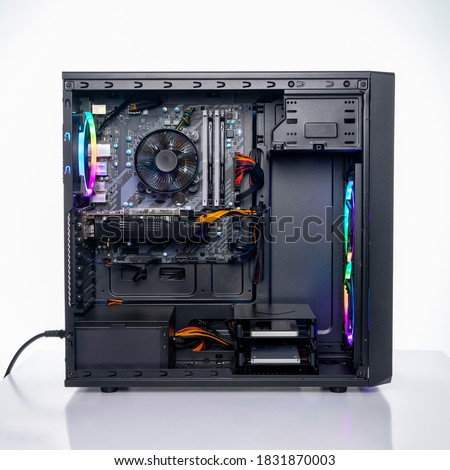 Studio shot of black Gaming desktop pc with rgb lights and visible components. Isolated on white background. Royalty-Free Stock Photo #1831870003
