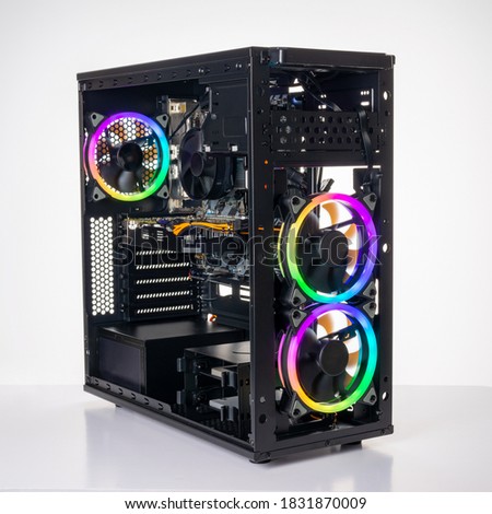 Studio shot of black Gaming desktop pc with rgb lights and visible components. Isolated on white background. Royalty-Free Stock Photo #1831870009