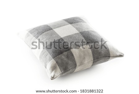 Grey and white checkered textile pillow on an isolated white background.
