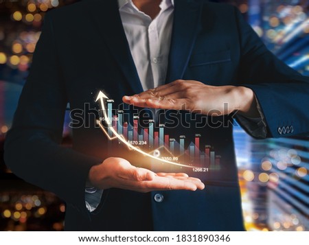 Businessman holding growth graph of business progress and analyzing financial investment data. Future growing growth plan.