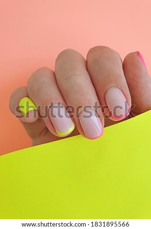  female hand beautiful manicure on a colored background