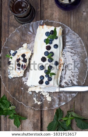 meringue roll with blueberries, mint and blackberries.