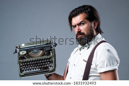 old fashioned bearded hipster. trendy man in bow tie use retro typewriter. confident and elegant man holding vintage equipment. literature and poetry. old technology in modern life. copy space.