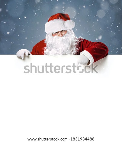 Happy Santa Claus pointing in blank white advertisement banner with copy space
