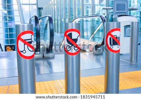Prohibition signs for luggage, suitcases, carts and baby carriages on an escalator in a public building