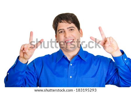 Closeup portrait, happy, excited successful young man giving peace, victory or two sign, isolated white background. Positive human emotions, face expressions, feelings, attitude, reaction, perception