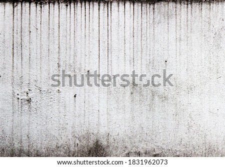 Vertical streaks of dirt on a white textured wall. Royalty-Free Stock Photo #1831962073