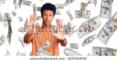 Young african american man wearing casual clothes doing stop gesture with hands palms, angry and frustration expression