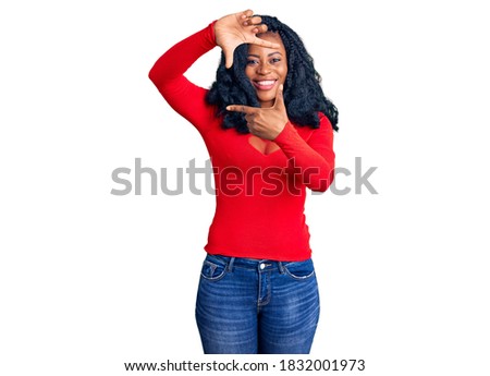 Beautiful african american woman wearing casual clothes smiling making frame with hands and fingers with happy face. creativity and photography concept. 
