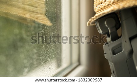 Drone in the rain soaked window. Sad rainy depressed weather and mood.