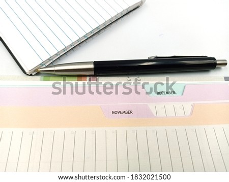 Notice diary with the pen on the isolated white background