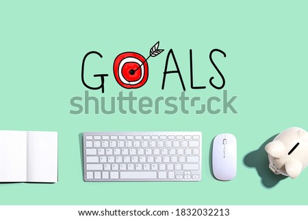 Goal concept with a computer keyboard and a piggy bank
