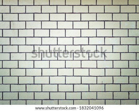 yellow brick wall with grunge background and vignetted.