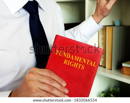 The Lawyer offers a book fundamental rights. Royalty-Free Stock Photo #1832066554