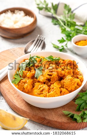 Cauliflower stew with curry, cumin, turmeric and other spices in a white bowl close-up. Curry roasted cauliflower. Royalty-Free Stock Photo #1832068615