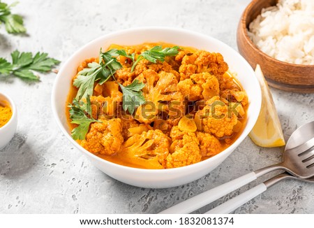 Cauliflower stew with curry, cumin, turmeric and other spices in a white bowl close-up. Curry roasted cauliflower. Royalty-Free Stock Photo #1832081374