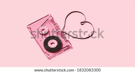 Minimal happiness object for love, wedding and valentine concept. Pink cassette tape with heart ribbon on pink background. 3d rendering illustration. Clipping path of each element included.