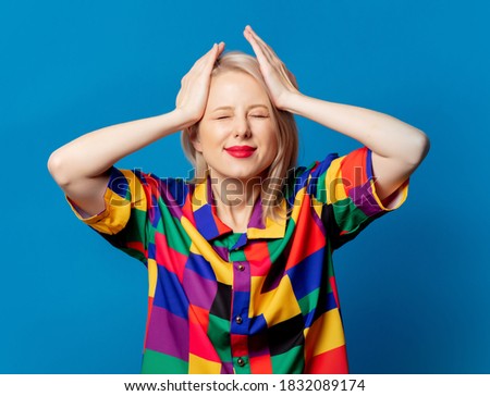 Blonde girl in 90s shirt on blue background 
