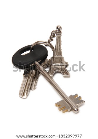 Apartment keys and Eiffel Tower keychain. Isolated items on white background