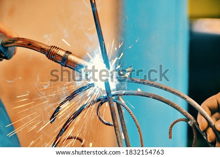 technician working with electric arc welding