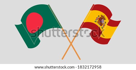 Crossed and waving flags of Bangladesh and Spain