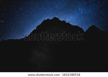 Dark mountain silhouette against backdrop of stars. Captured at Zion National Park in Utah, USA.