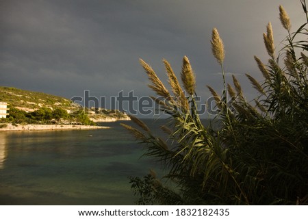 sardinian landscape in calamosca in a day between sunny and rainy weather