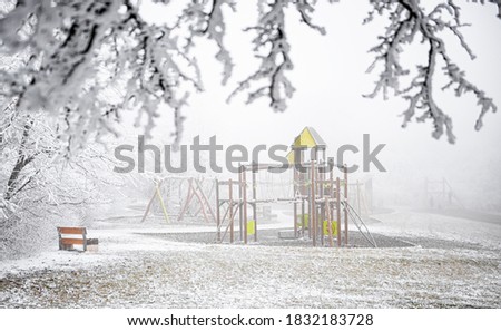Playground in winter covered with snow