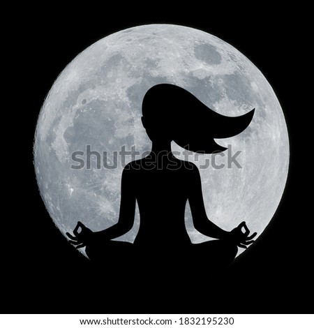 Silhouette woman performing yoga in front of full moon at night