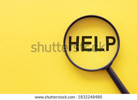 text HELP on the magnifier glass on yellow background. Search help concept