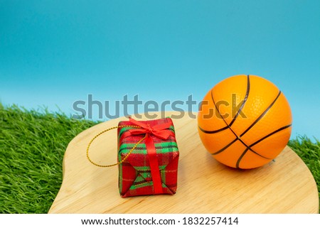 Basketball on Christmas Holiday with gift ornament on wooden floor