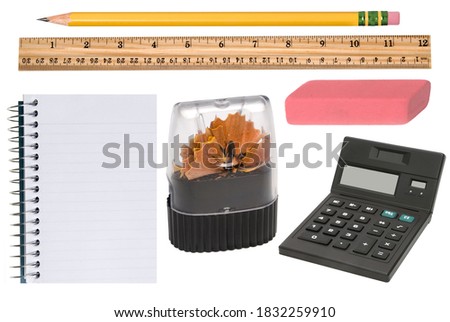 Isolated office supplies in new condition incluldes a freshly sharpened pencil, pencil sharpener, eraser, notepad and calculator.  
