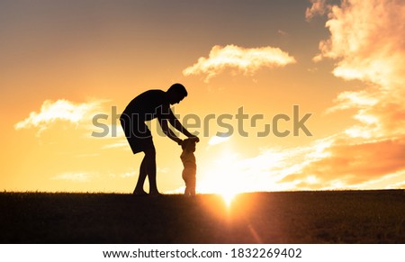 Father teaching baby learn to walk. Fatherhood, parenting, and baby steps concept 