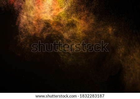 abstract powder splatted background,Freeze motion of color powder exploding/throwing color powder,
 multicolored glitter texture on black background.