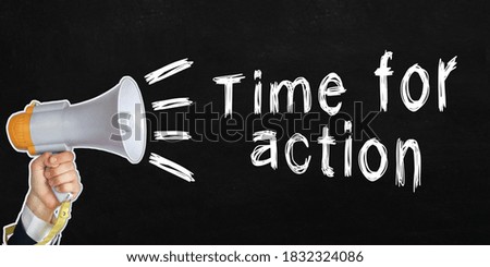 A businessman speaks into a loudspeaker, next to the text - Time for action. No face visible. Black background
