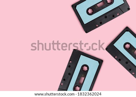 Cassette tapes on a pink pastel background. Creative template with copy space.