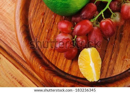 fresh raw red grape on wooden table