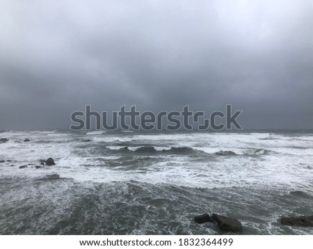 Atmosphere of windy and surf against gloomy sky before storm coming. Storm sure against dark cloudy sky. Terrible view of typhoon at ocean coast, Japan. Royalty-Free Stock Photo #1832364499