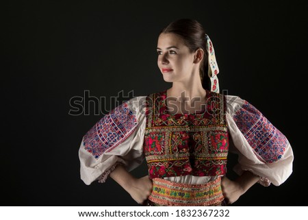 Detail of woman dress. She is wearing traditional Eastern Europe folk costumes.