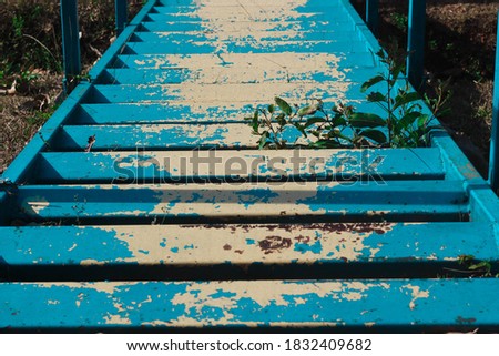 Blue stairs that has peeled off.