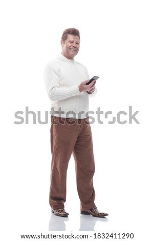 full- length . smiling man reading a message on his smartphone