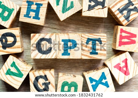 Alphabet letter block in word CPT (Abbreviation of Carriage Paid To) with another on wood background