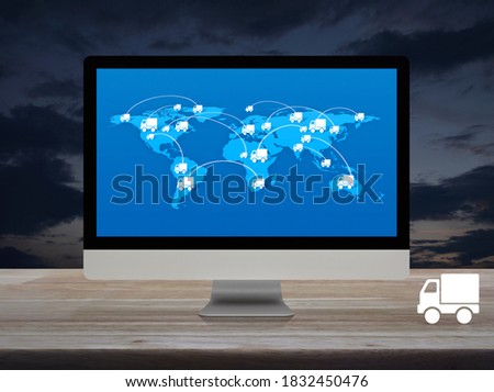 Delivery truck flat icon with connection line and world map on modern computer monitor screen on wooden table over sunset sky, Transportation online concept, Elements of this image furnished by NASA