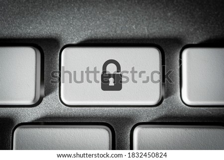 Padlock security key on a neat white keyboard