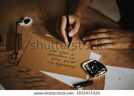 Someone using fountain pen and writing words, sending letter. Royalty-Free Stock Photo #1832451424