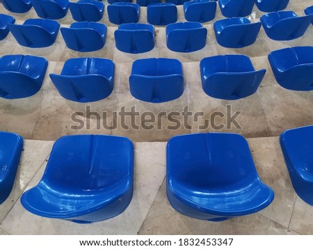 Blue seats in the stands of the gym.