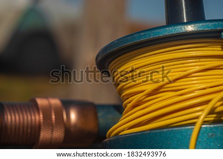 Fly fishing tackle on a wooden background, including reel and line. Close-up.
