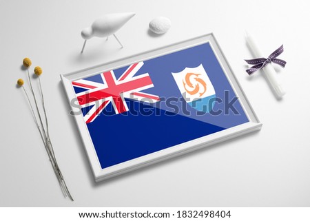Anguilla flag in wooden frame on table. White natural soft concept, national celebration theme.