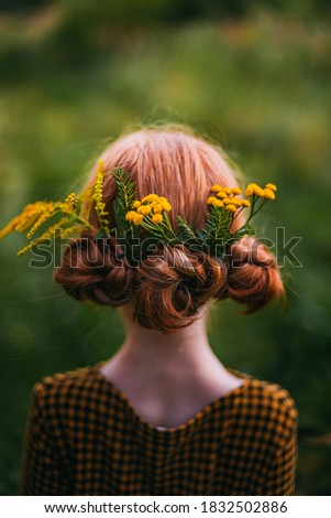beautiful hairstyle of red hair with flowers