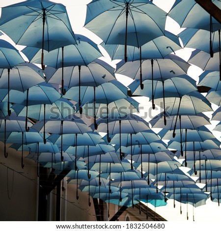 Low angle view on contemporary installation if blue umbrellas